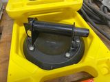a yellow box with a black handle on it