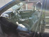 the interior of a car with the door open and the driver ' s seat up