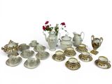 many different types of teapots and saucers on the table