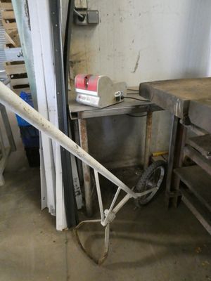 a wheelbarrow leaning against a wall in a garage