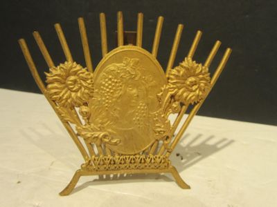 a gold plate with a picture of a woman on it