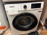 a washer and a dryer in a small room