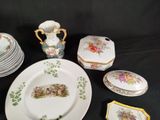 many plates, cups, and a vase on a table