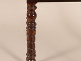 a small wooden table with a drawer on top of it