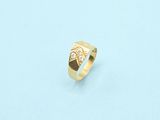 a close up of a gold ring on a white surface