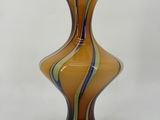a glass vase that is sitting on a white surface