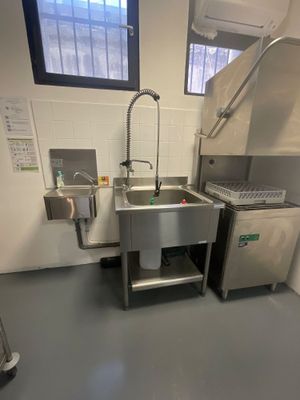 a kitchen with a sink and a dishwasher in it