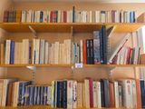 a bookshelf with many books on it in a room