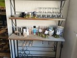 a shelf with wine glasses on it in a room