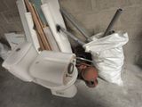 a white toilet sitting next to a pile of toilet paper