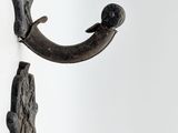 two hooks on the wall that have a bird on them
