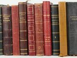 many books that are lined up on a shelf