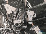 a pile of black plastic bags with tags on them