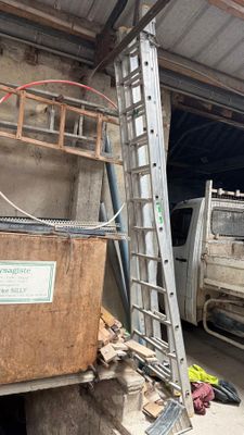 un camion garé devant un immeuble, avec une échelle