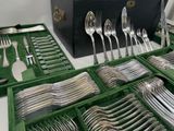many silverware in the trays on the table