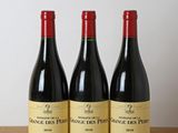 three bottles of wine sitting on top of a wooden table