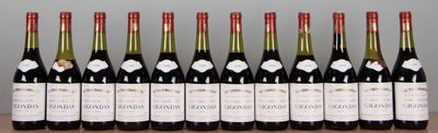 six bottles of wine are lined up on a wooden table