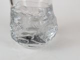 a glass with water in it sitting on a table