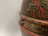 an old wooden box with a red and gold design on it