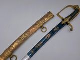 two swords, one of which is decorated with gold and the other of which has a blue handle