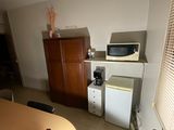 a small kitchen with a table and a microwave in it
