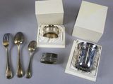 a silverware set in a white box with a silver spoon and fork