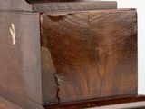an old wooden box with a wooden handle on a white surface
