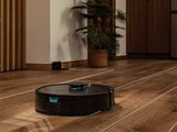 un robot posé par terre à côté d'une plante