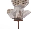 sculpture of a head on a wooden stand with a white background