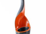 an orange and black vase on a white background