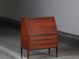 a small wooden desk on a wooden floor in a room