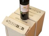 a bottle of wine sitting on top of three boxes