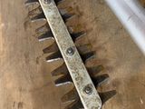 a close up of a metal hedger on a wooden table
