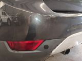 the rear end of a car with the tail lights on