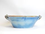blue and orange bowl with handles on white background