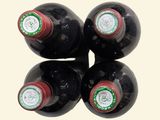 four bottles of wine are stacked on top of each other