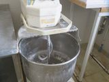 a mixer that is sitting on a stand in a kitchen