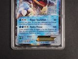 a close up of a pokemon trading card in a plastic container