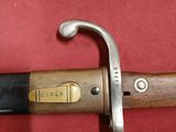 a close up of a sword on a red surface