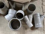 many different types of pipes and fittings on the ground