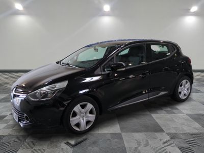 the black car is parked on a checkered floor in the garage