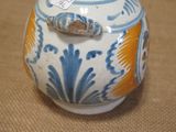 a small blue and white vase with a fish on it