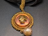 gold plated necklace with a pendant and a pearl bead