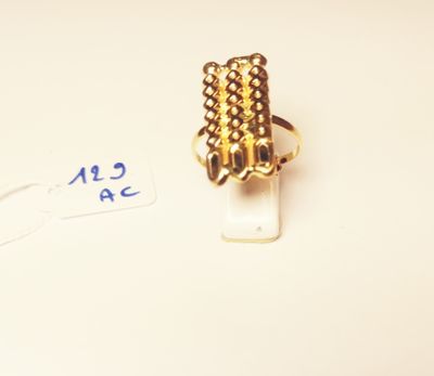 a gold ring that is sitting on top of a piece of paper