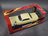 toy car in a box on a table with a man standing next to it