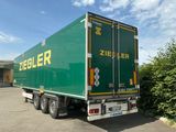 un camion vert garé sur un parking