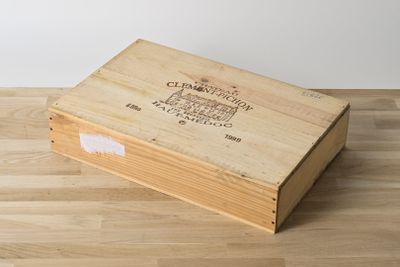 an empty wooden box sitting on top of a wooden floor