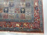 an antique persian rug with a blue and red design