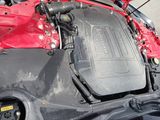 a red car engine with the hood open