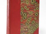 an old book with a red cover and a pattern on the cover